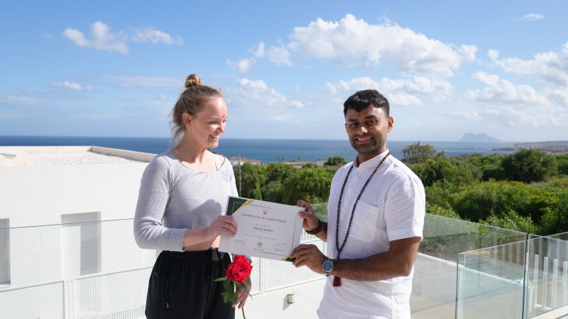 Sarah receiving her yoga teacher training certificate